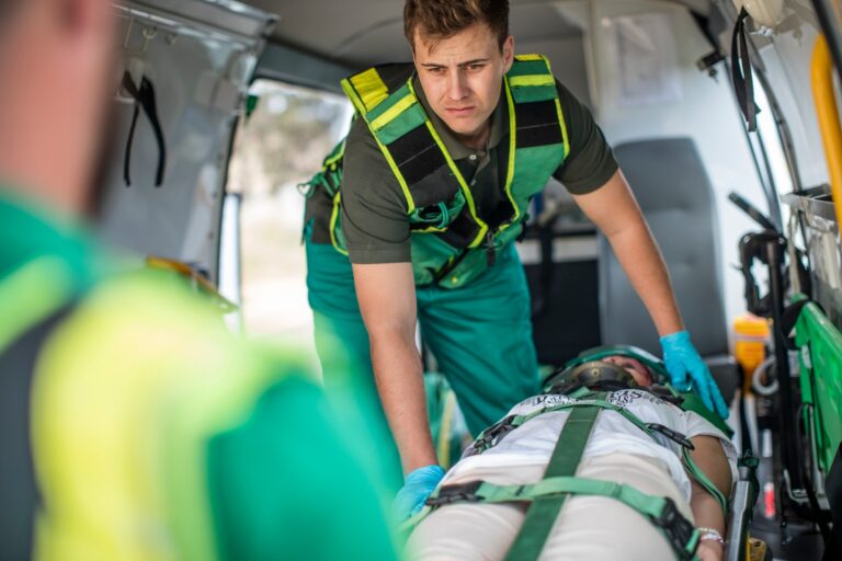 Paramedics moving car crash victim on stretcher